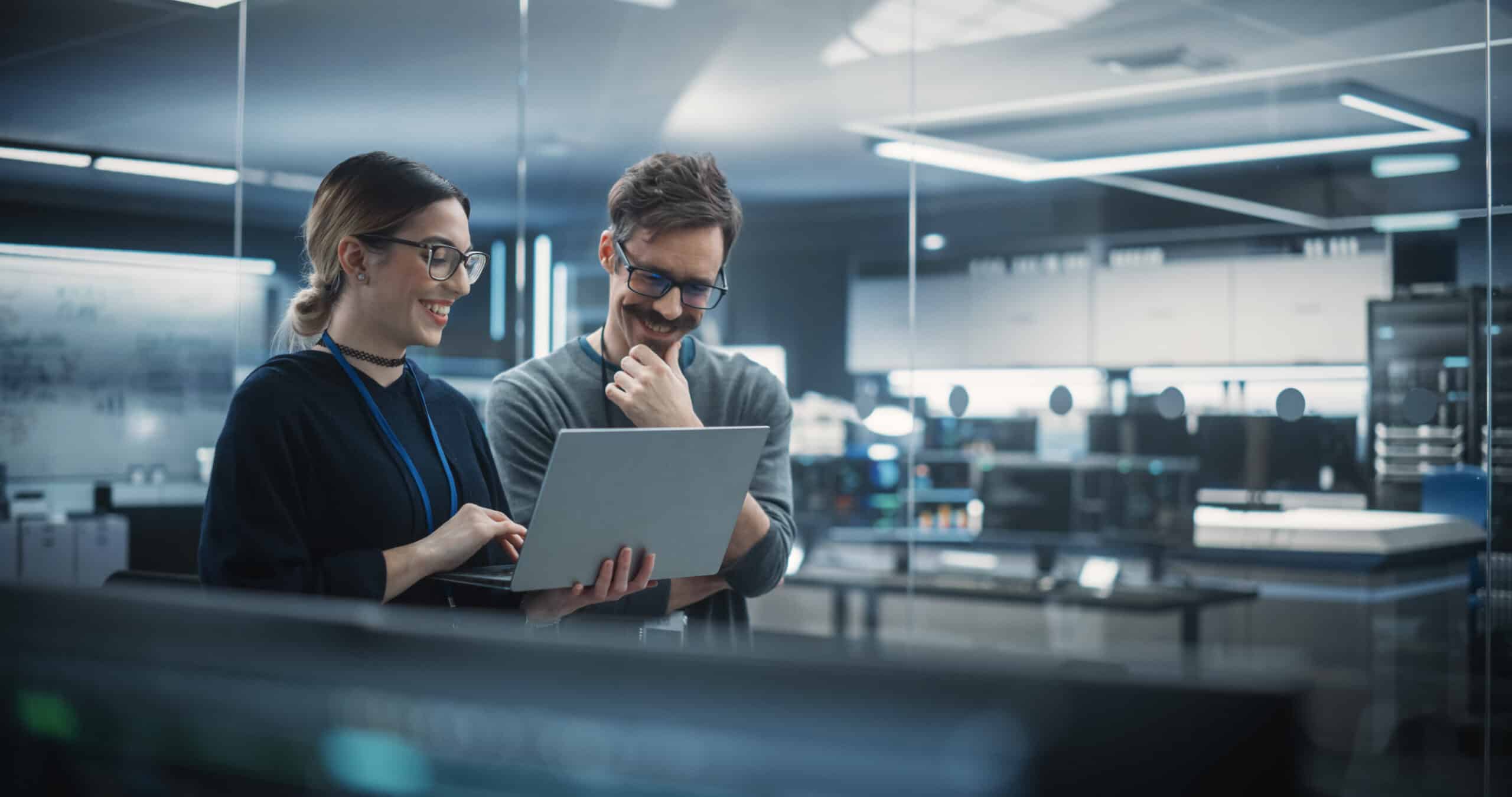 Portrait of Two Creative Young Female and Male Engineers Using L